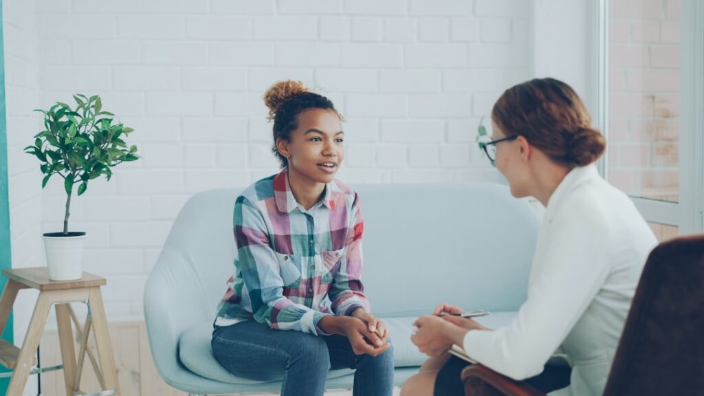 Two people having a supportive conversation in a modern setting